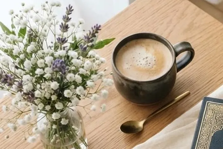 A quiet study corner with flowers and a warm drink